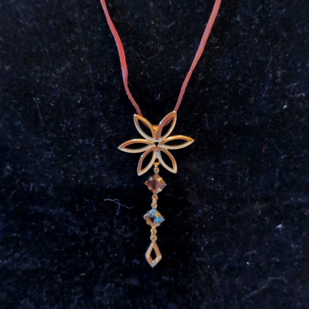 Statement Gold Toned Daisy Pendant with Dangling Crystal Stem